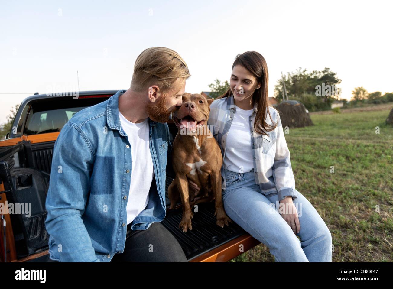 Cute young couple with a dog Stock Photo - Alamy