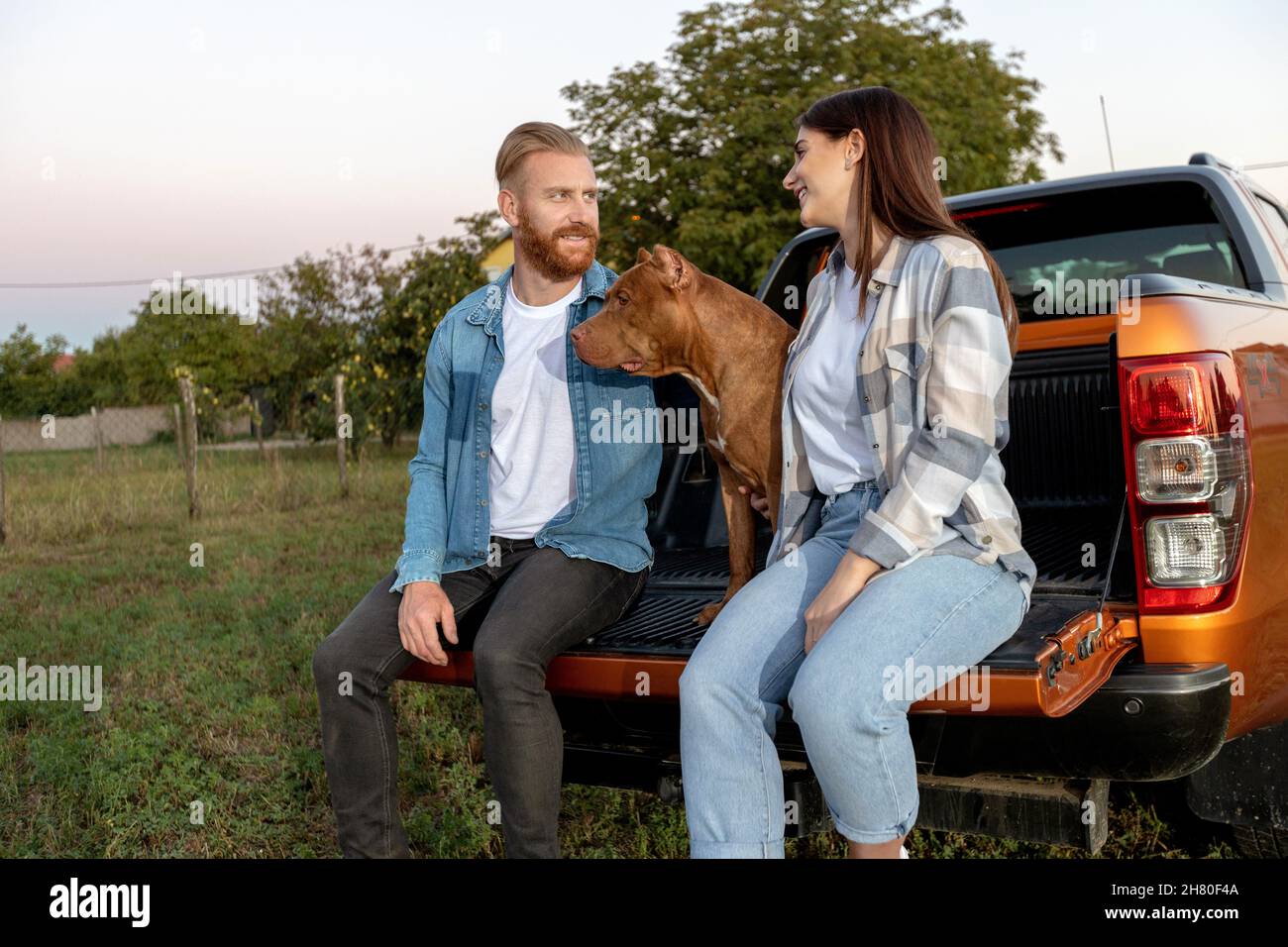 Cute young couple with a dog Stock Photo - Alamy