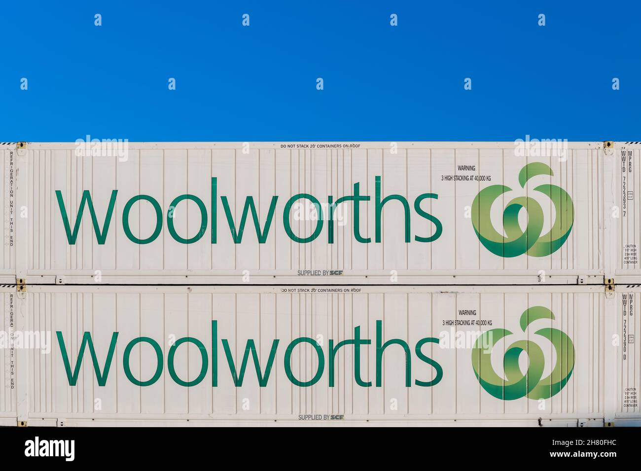 Adelaide, Australia - February 16, 2020: Woolworths refrigerated shipping containers stacked against blue sky on a day Stock Photo