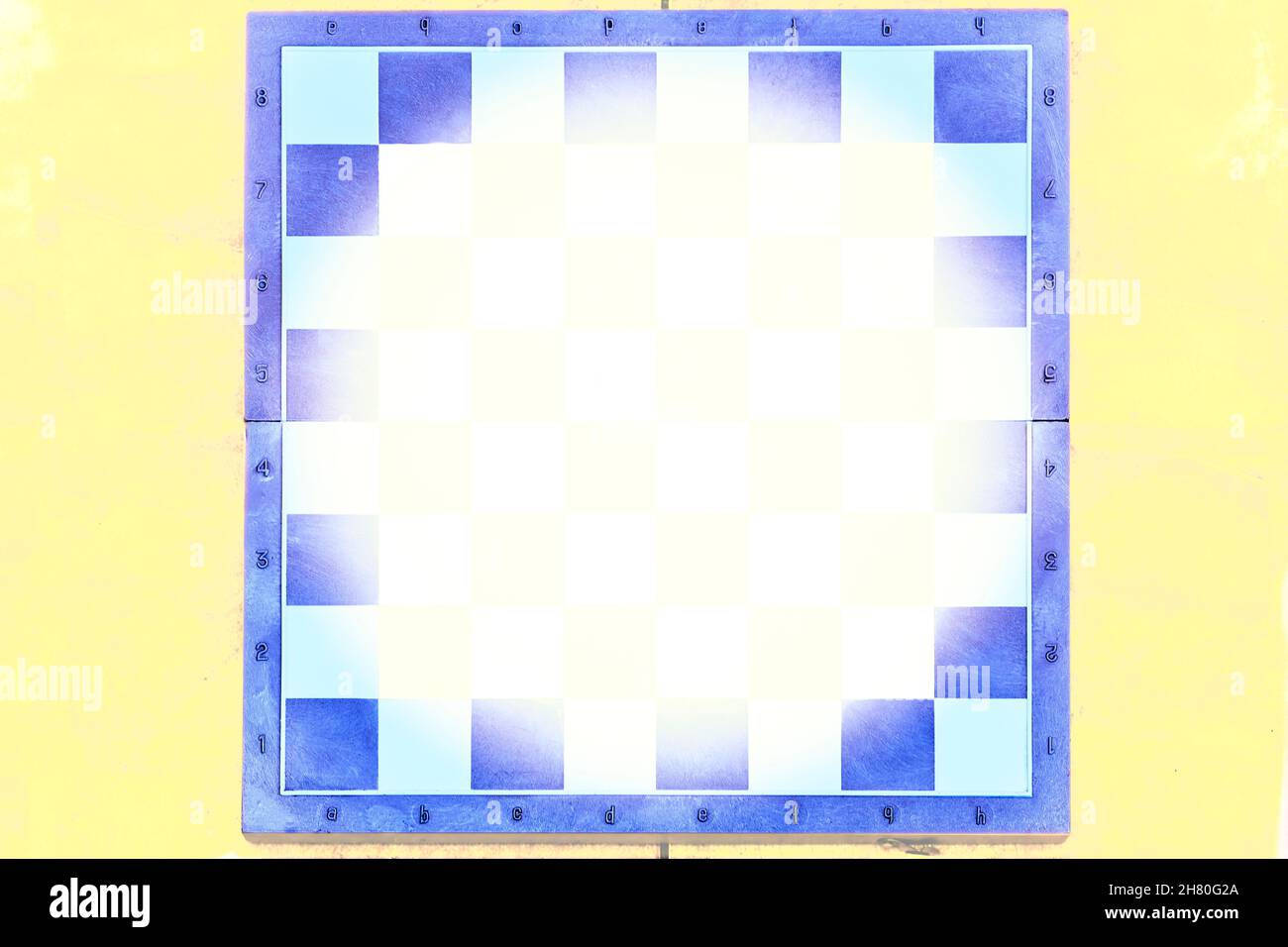 Blue chess board on yellow background with place for text Stock Photo
