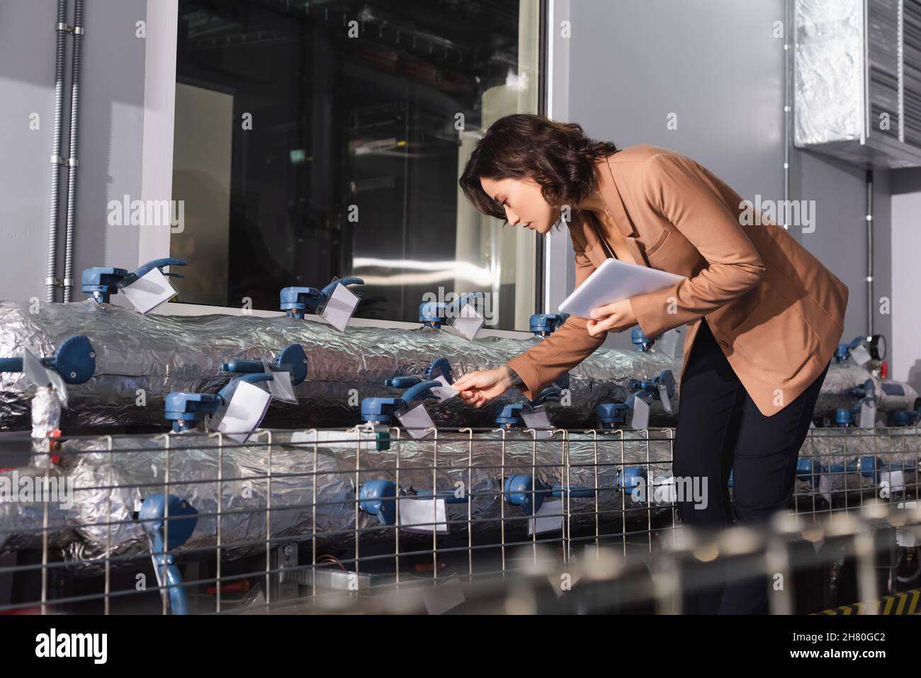 engineer with digital tablet checking cooling system of data center Stock Photo