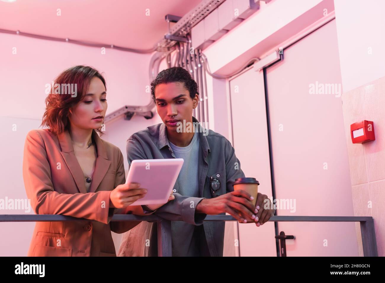 young interracial engineer with digital tablet working in data center Stock Photo