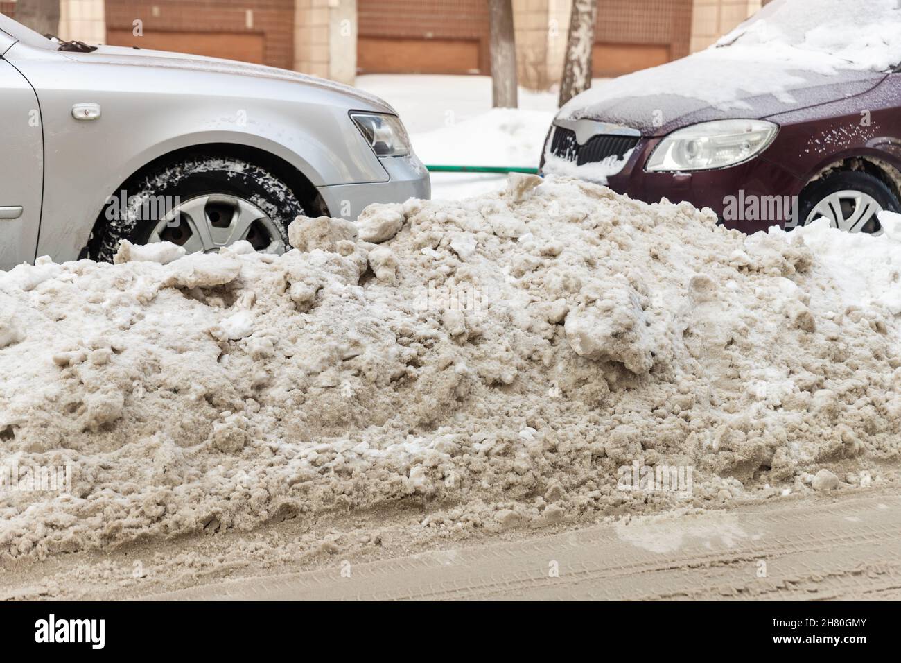 City street driveway parking lot with many cars covered by snow stucked ...