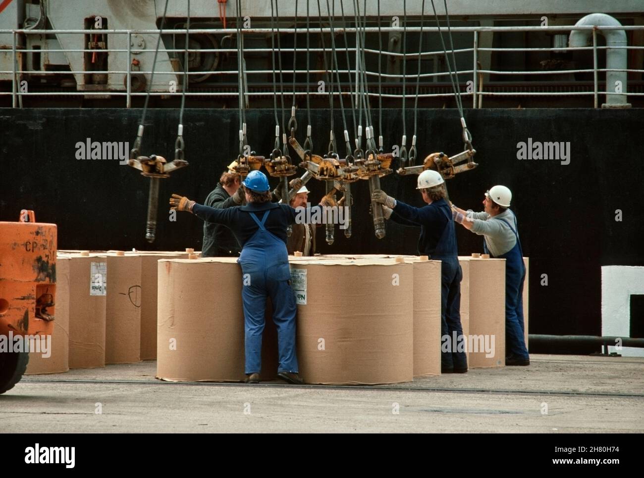 Paper rolls being prepared for lift-on with special loading gear at Cellpap Terminal in the Port of Hamburg. Stock Photo