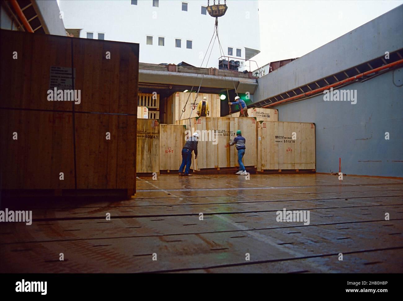 Crates containing machine components being loaded on a multipurpose vessel in the Port of Kiel, Schleswig-Holstein, Germany. Stock Photo