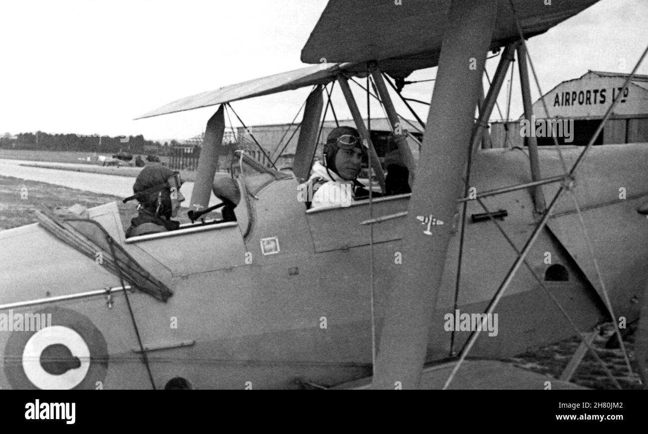 16th August 1943, No.9 EFTS RAF training school, at Clyffe Pypard (near Swindon), Wiltshire, England. Eight months after his call-up in Northern Ireland, an apprehensive RAF trainee is about to take his first flight. The aircarft is a Tiger Moth biplane. This was the first of seventeen training flights before he was shipped to Canada in November 1943 to start training at Picton bomb and gunnery school. Stock Photo