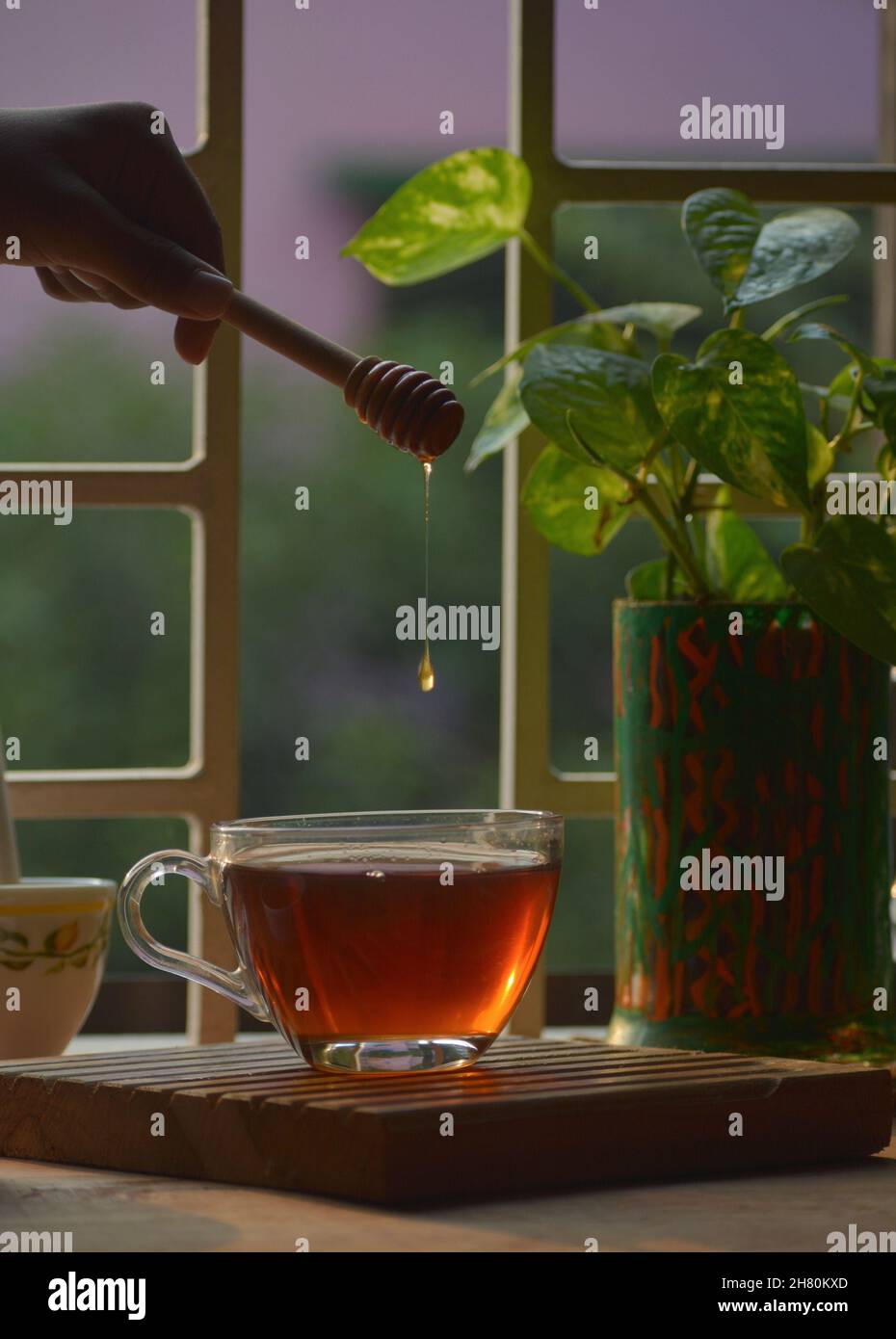 Tea with honey drop Stock Photo Alamy