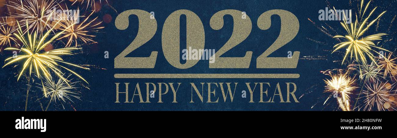 HAPPY NEW YEAR 2022 - Festive silvester New Year's Eve Party background panorama greeting card banner long - Golden fireworks in the dark blue night Stock Photo