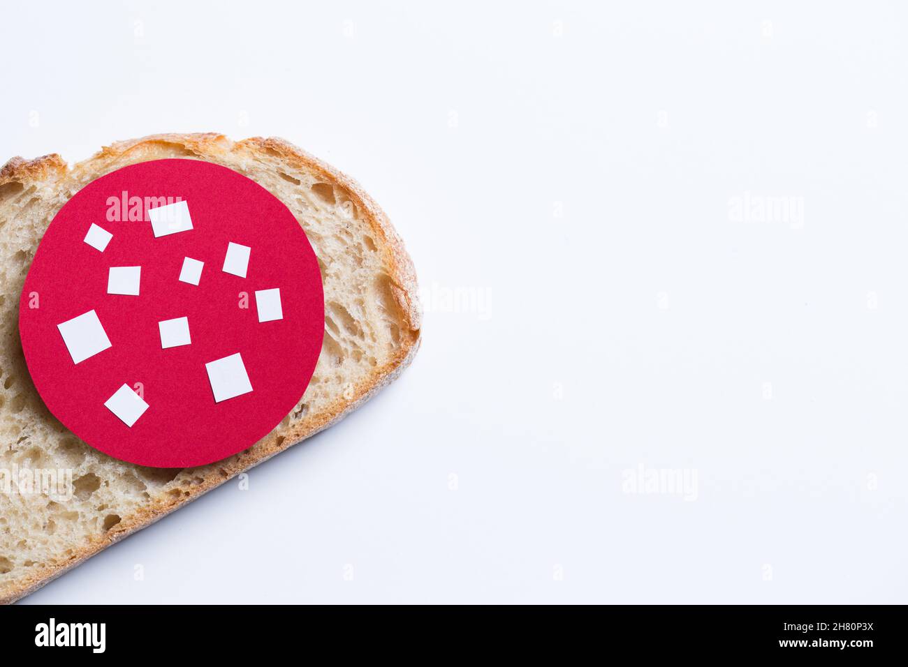 The slice of bread with paper cut out salami. Stock Photo