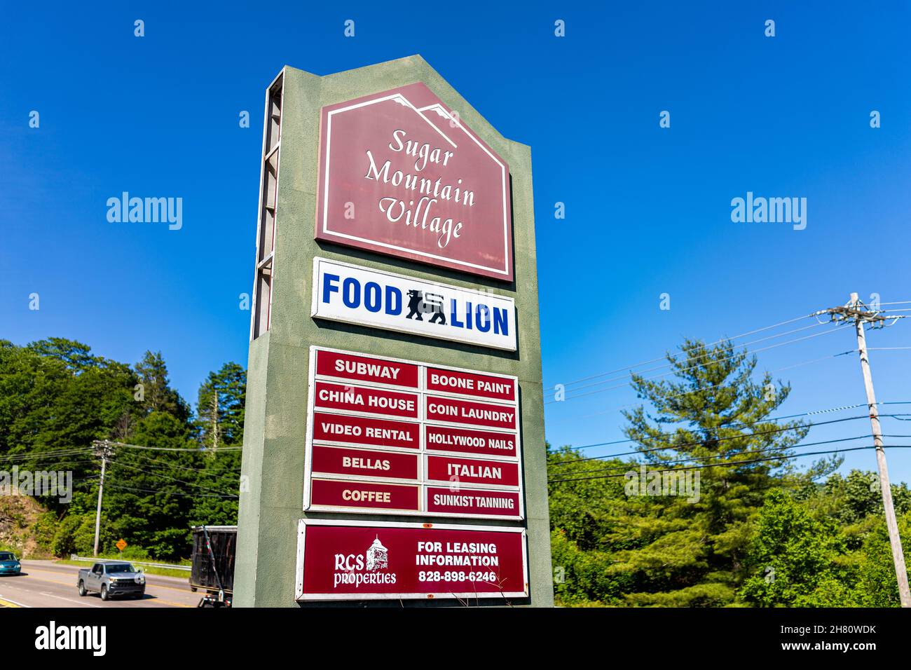Banner Elk, USA - June 17, 2021: Local store strip mall sign for Food Lion grocery shop in NC North Carolina near Sugar Mountain Village and Subway, C Stock Photo