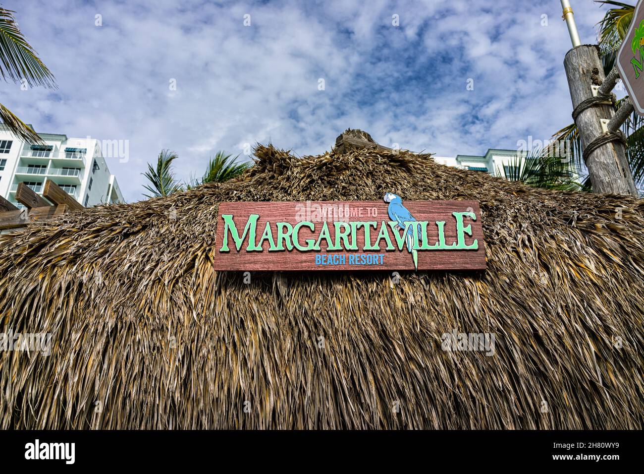 Hollywood, USA - August 4, 2021: North of Miami Beach, Hollywood broadwalk boardwalk in Florida with sign on tiki hut entrance to Margaritaville resta Stock Photo