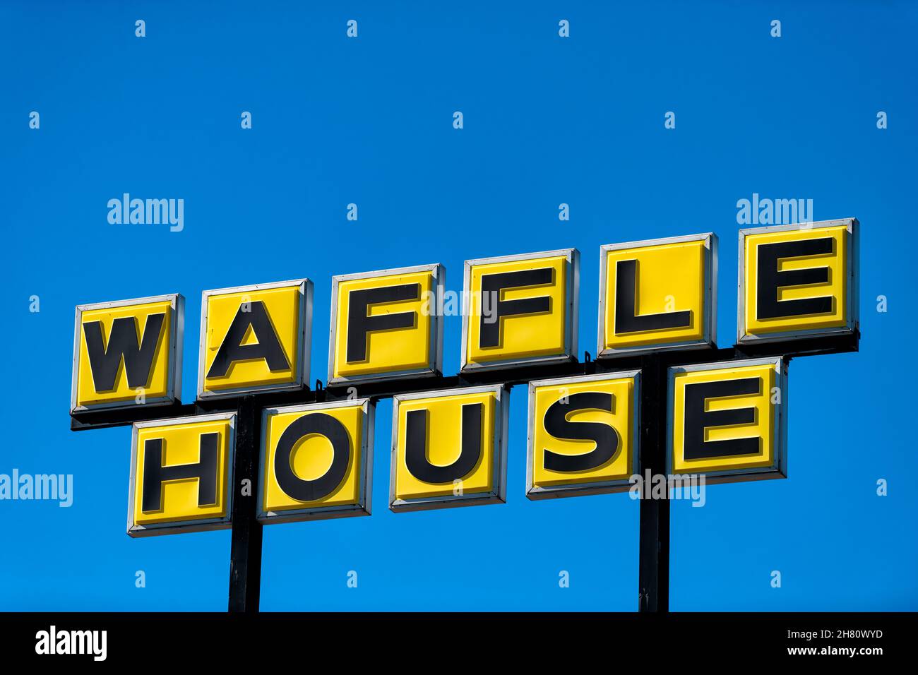 Tampa, USA - February 3, 2021: Sign closeup for Waffle House in Florida isolated against blue sky for fast food breakfast chain Stock Photo