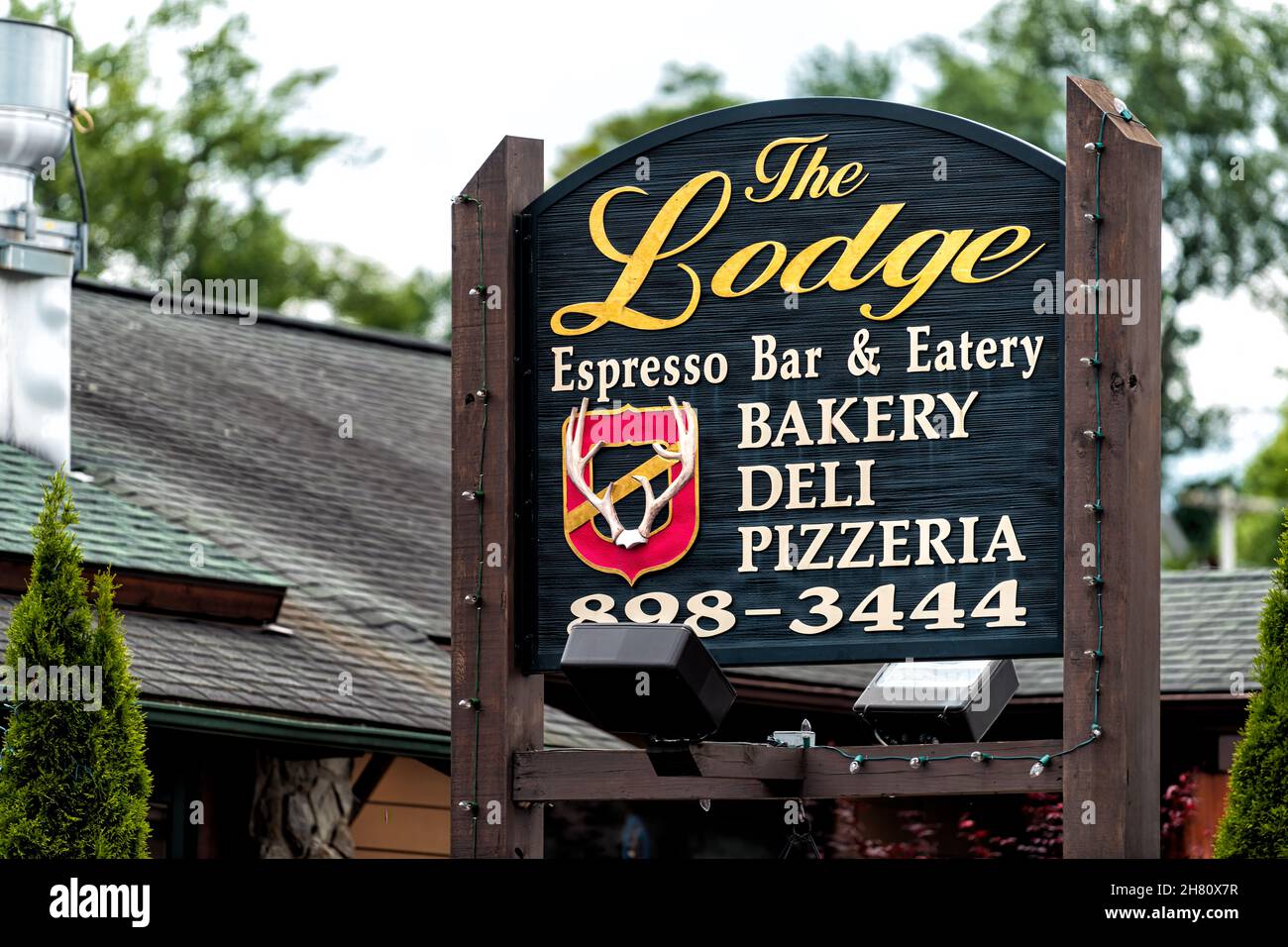 Banner Elk, USA - June 23, 2021: Downtown Banner Elk in North Carolina city town with sign for the Lodge Espresso Bar and Eatery restaurant by Sugar a Stock Photo
