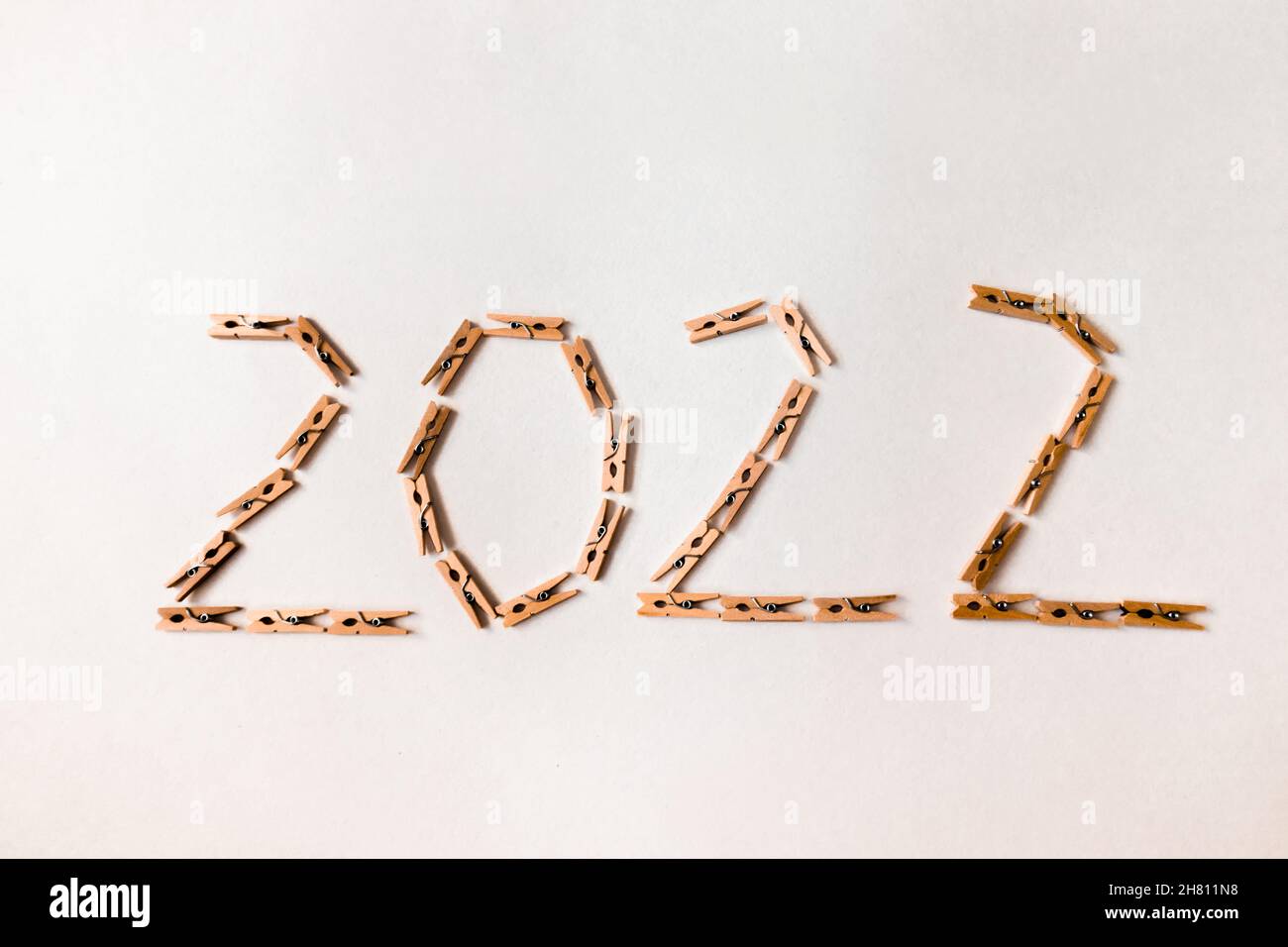 Number 2022 is made of small clothespins on a white background. Stock Photo