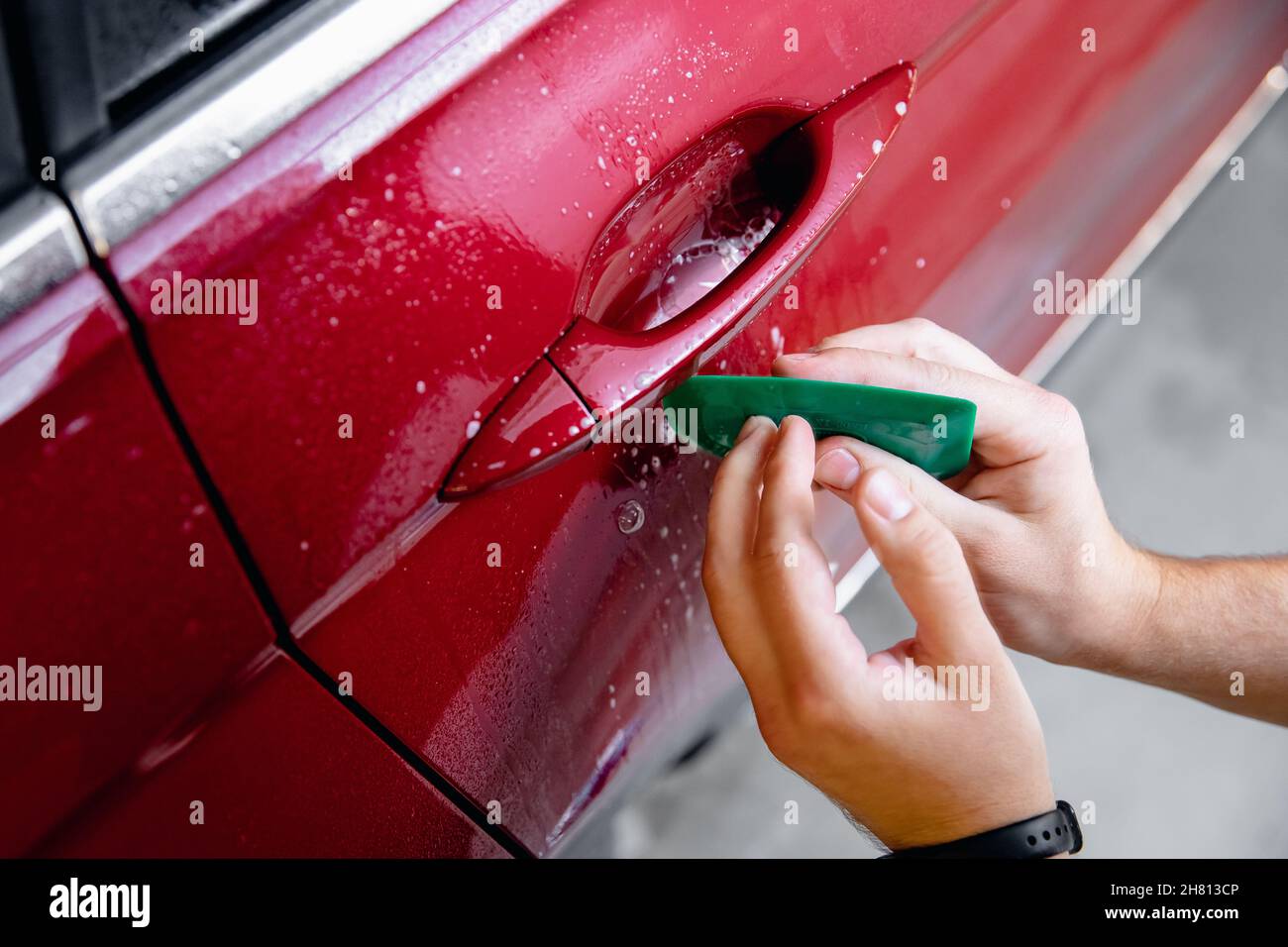 Master installation on in risk zone under handles red car. Paint
