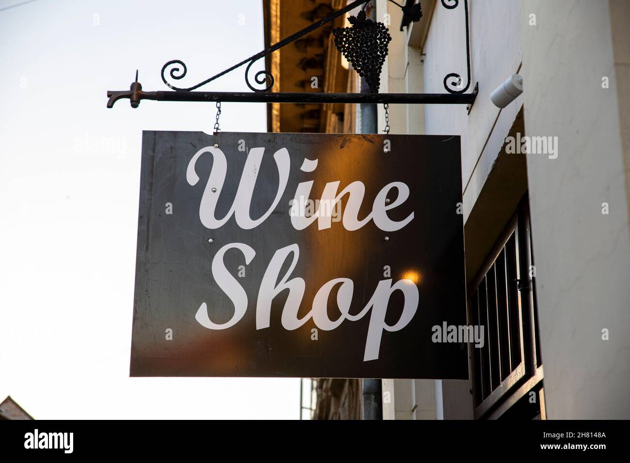 Wine shop sign hanging from old building Stock Photo Alamy