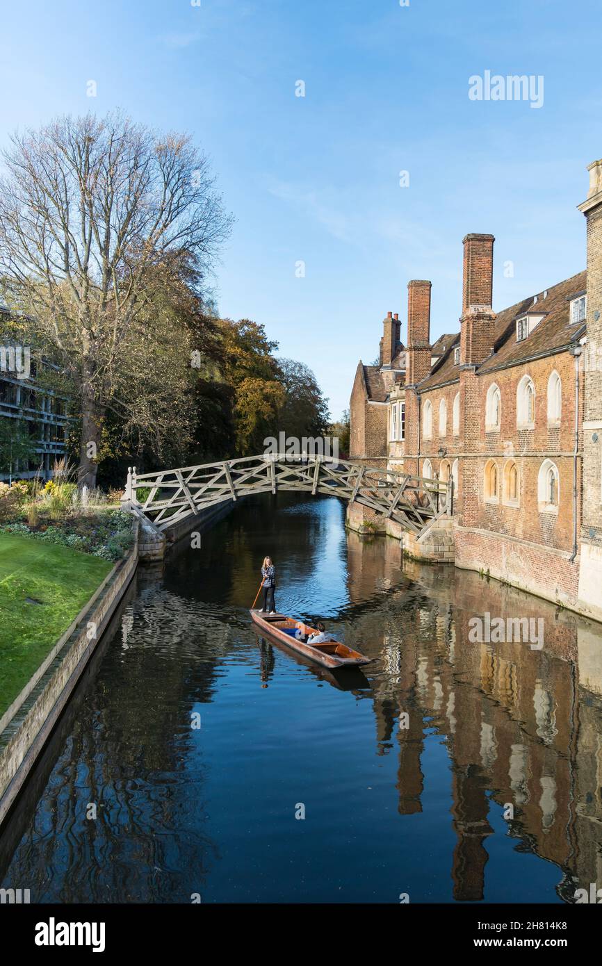 Young woman punting male in punt on river Cam at Queens college Cambridge 2021 Stock Photo