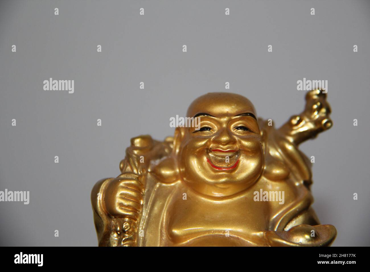 Smiling Buddha Chinese god of happiness, wealth and luck isolated on white background Stock