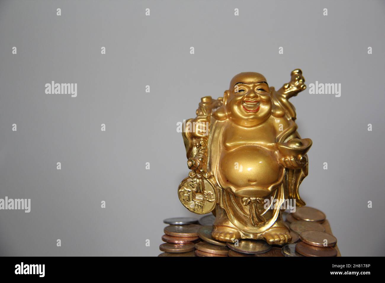 Smiling Buddha - Chinese god of happiness, wealth and luck isolated on white background. Stock Photo