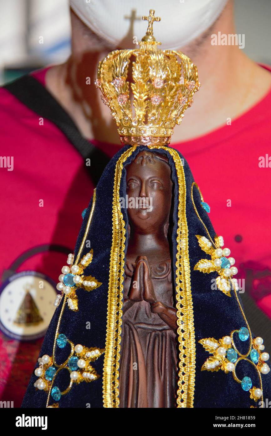 Close-up of the image of Our Lady of Aparecida, in the hands of a man. Stock Photo