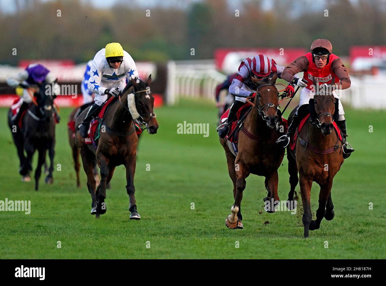 Dolphin Square ridden by jockey David Maxwell (right) on their way to winning the Play Ladbrokes 1-2-Free On Football Handicap Hurdle with Flemcara ridden by jockey Thomas Bellamy (second right) second and Eyeofthescorpion ridden by jockey Paddy Brennan third at Newbury Racecourse. Picture date: Friday November 26, 2021. See PA story RACING Newbury. Photo credit should read: Adam Davy/PA Wire. RESTRICTIONS: Use subject to restrictions. Editorial use only, no commercial use without prior consent from rights holder. Stock Photo