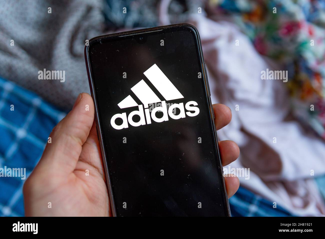 Spain. 26th Nov, 2021. The fashion retailer Adidas mobile app logo is seen on screen of a mobile phone in Barcelona, Spain on November 26, 2021. Online shopping is very popular