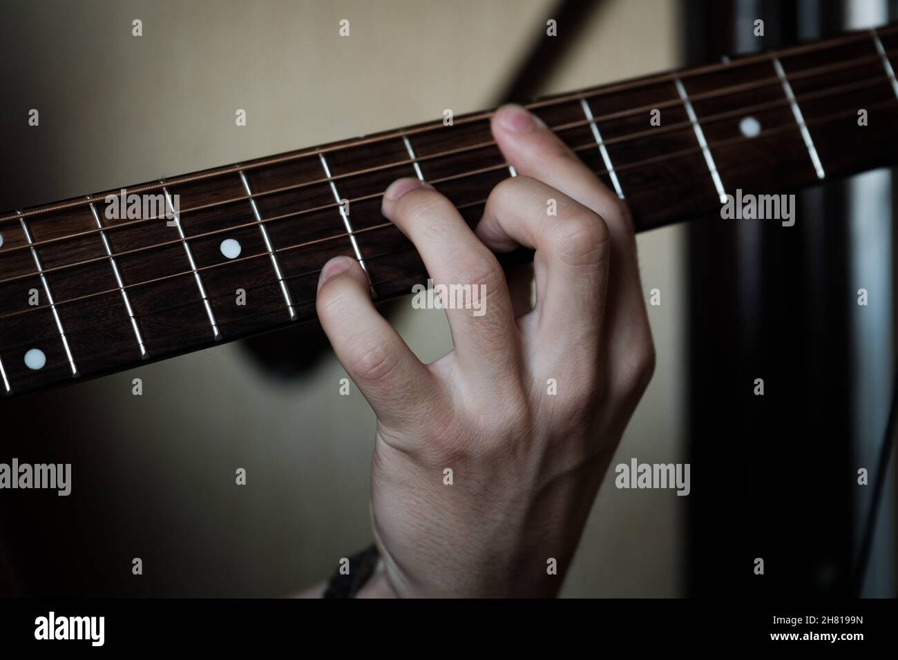 Hand playing masterly on a guitar. Stock Photo