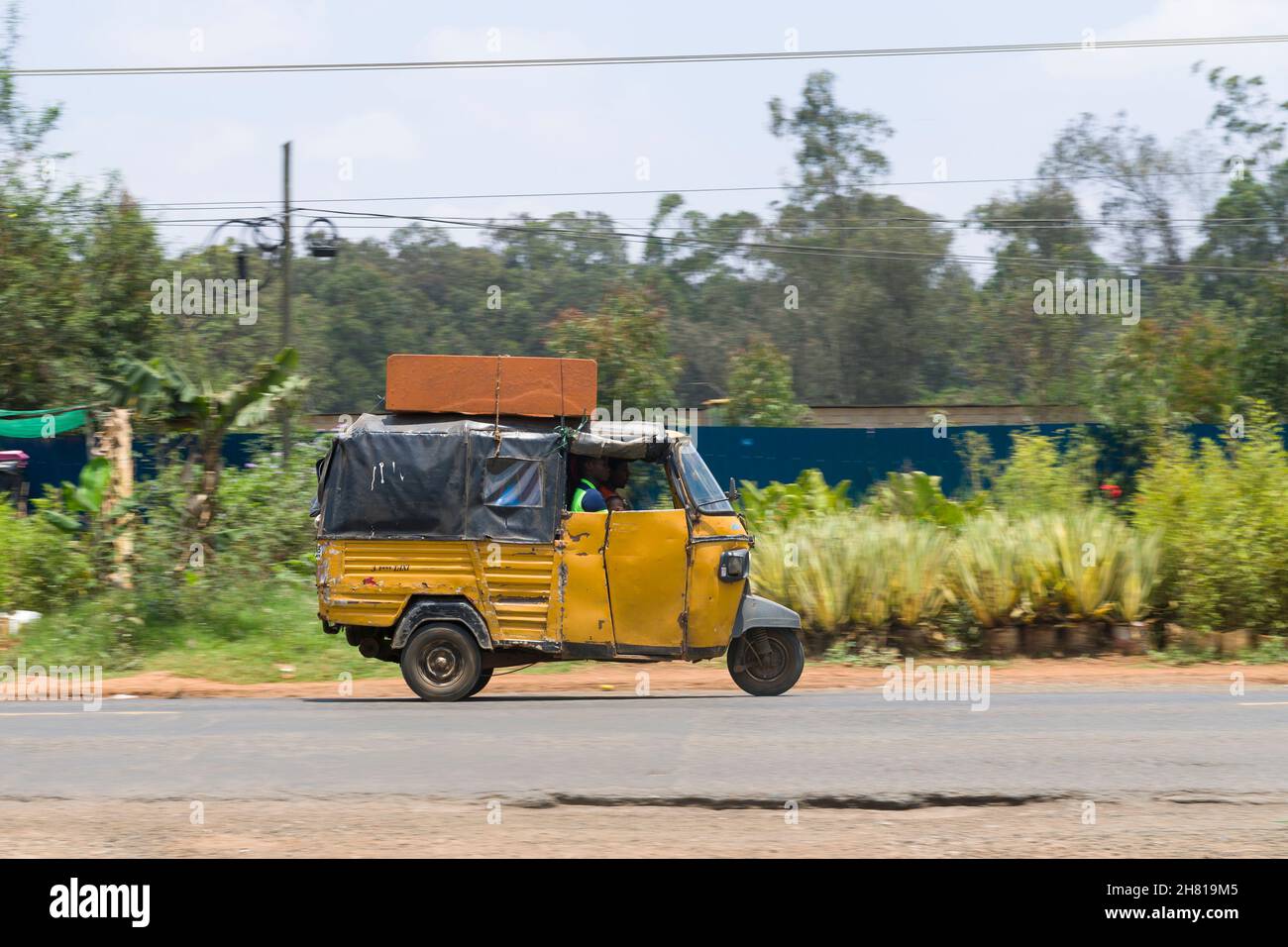 An auto rickshaw taxi which are know locally as a Tuk Tuk, they are used for passengers and goods. Ngong Road, Karen, Nairobi, Kenya.  10 Oct 2021 Stock Photo