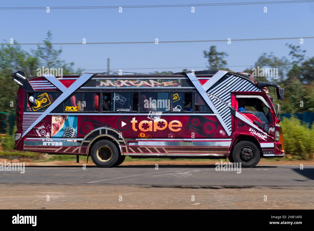 Bus with customised paintwork driving along Ngong road. Many buses in ...
