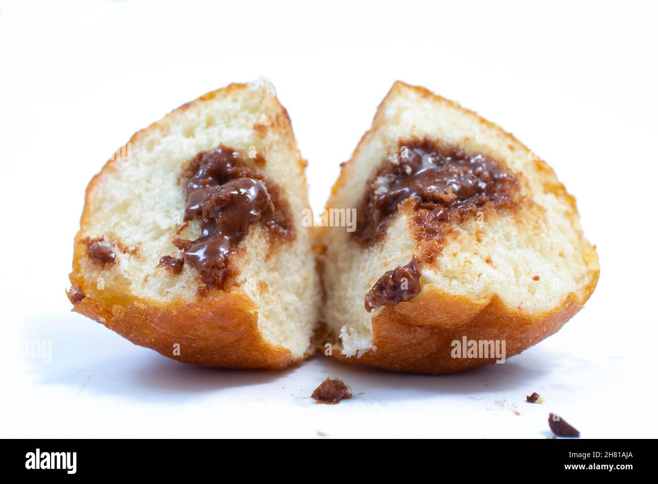 small round donuts with chocolate filling on white background. Stock Photo