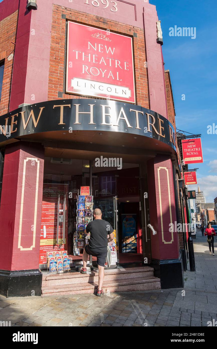 Man looking at leaflets of forthcoming attractions at New Theatre Royal Lincoln 2021 Stock Photo