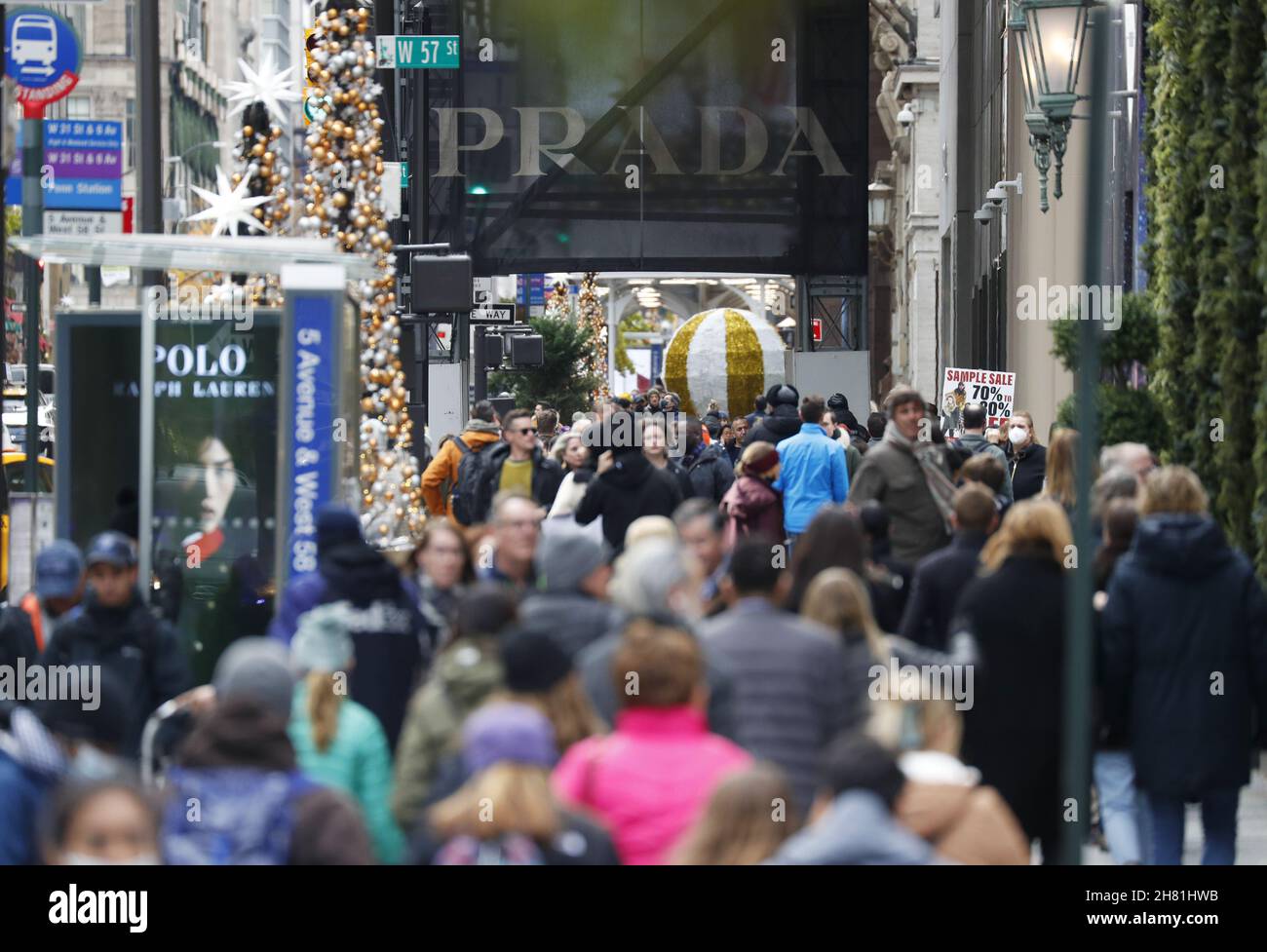 New York, USA. 26th Nov, 2021. Shoppers and pedestrians walk on Fifth Avenue near a Prada retail store on Black Friday in New York City on Friday, November 26, 2021. For over a decade, Black Friday has traditionally been the official start to the busy buying binge sandwiched between Thanksgiving and Christmas. Photo by John Angelillo/UPI Credit: UPI/Alamy Live News Stock Photo