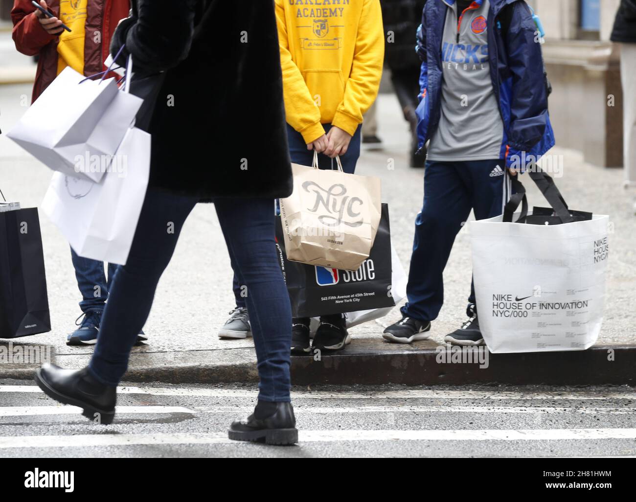 New York, USA. 26th Nov, 2021. Shoppers hold shopping bags while walking on Fifth Avenue on Black Friday in New York City on Friday, November 26, 2021. For over a decade, Black Friday has traditionally been the official start to the busy buying binge sandwiched between Thanksgiving and Christmas. Photo by John Angelillo/UPI Credit: UPI/Alamy Live News Stock Photo