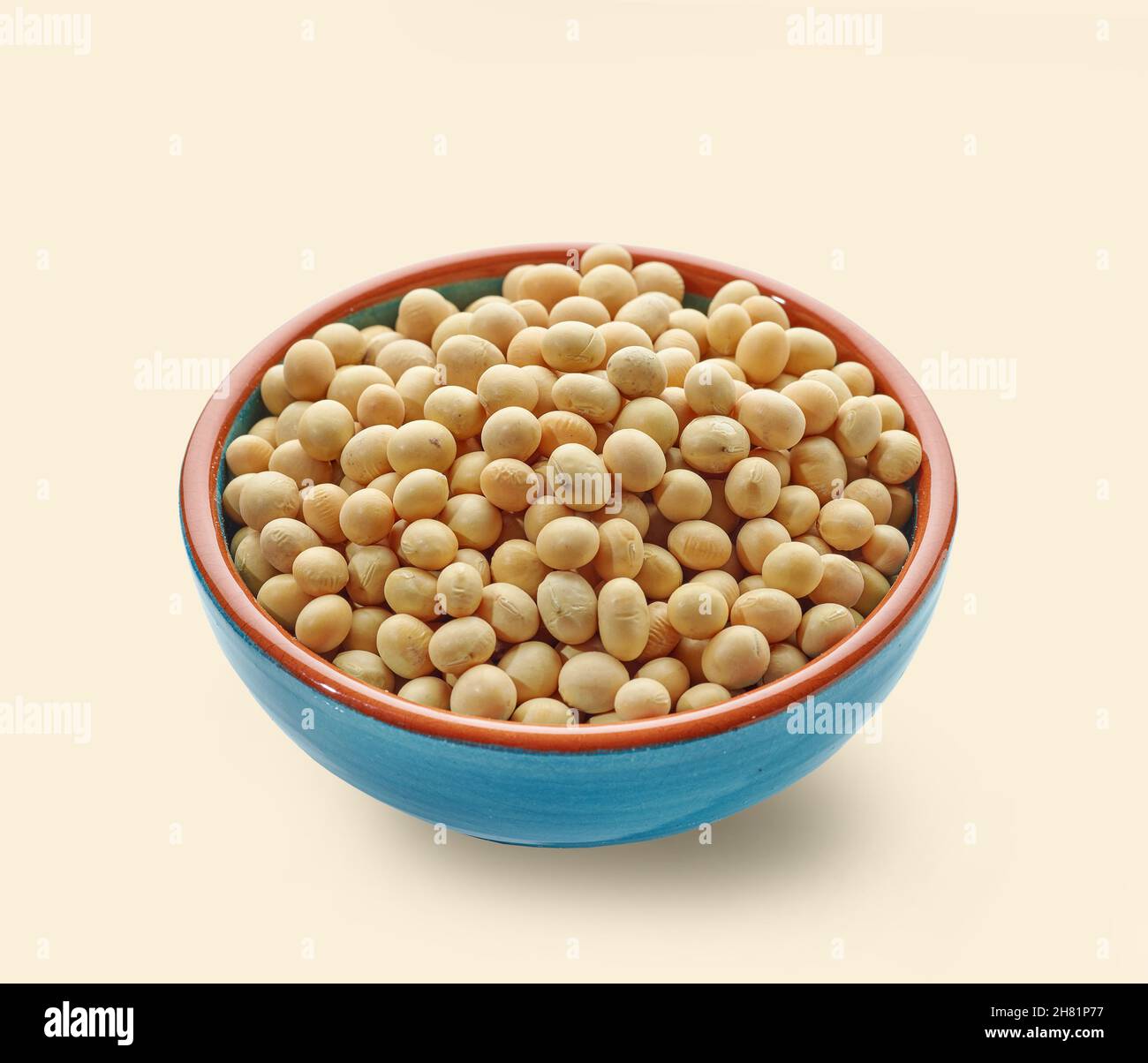 bowl of soy beans isolated on beige color background Stock Photo