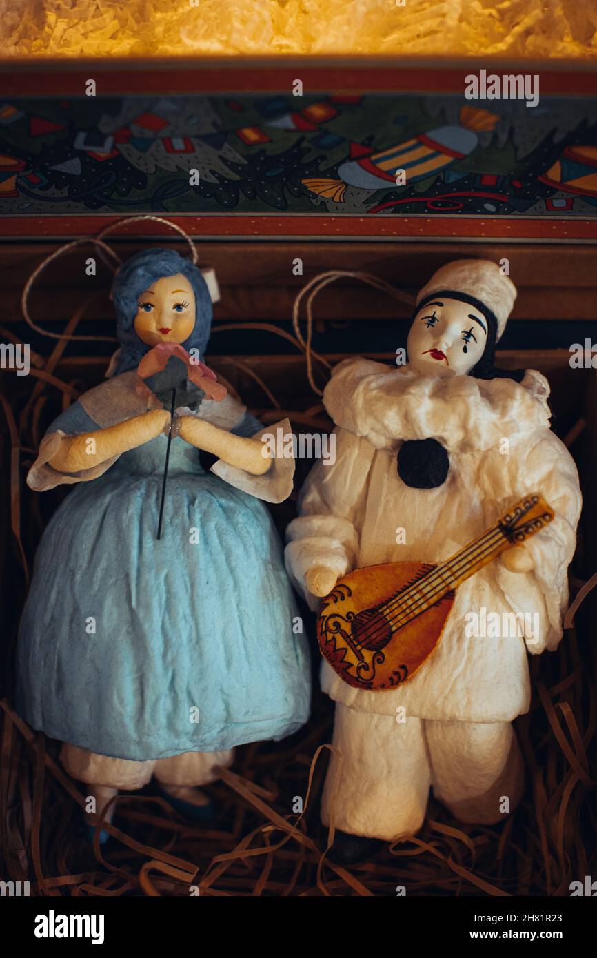 Vintage toys figurines of Malvina and Pierrot lying in a gift box. Festive decor and details Stock Photo
