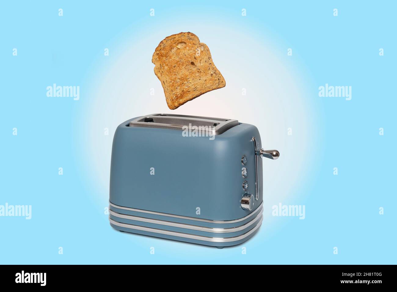 Modern retro style toaster with a slice of bread jumping out Stock