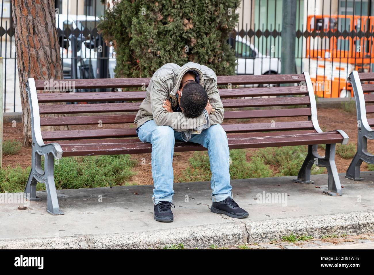 Homeless man sitting on bench hi-res stock photography and images - Alamy