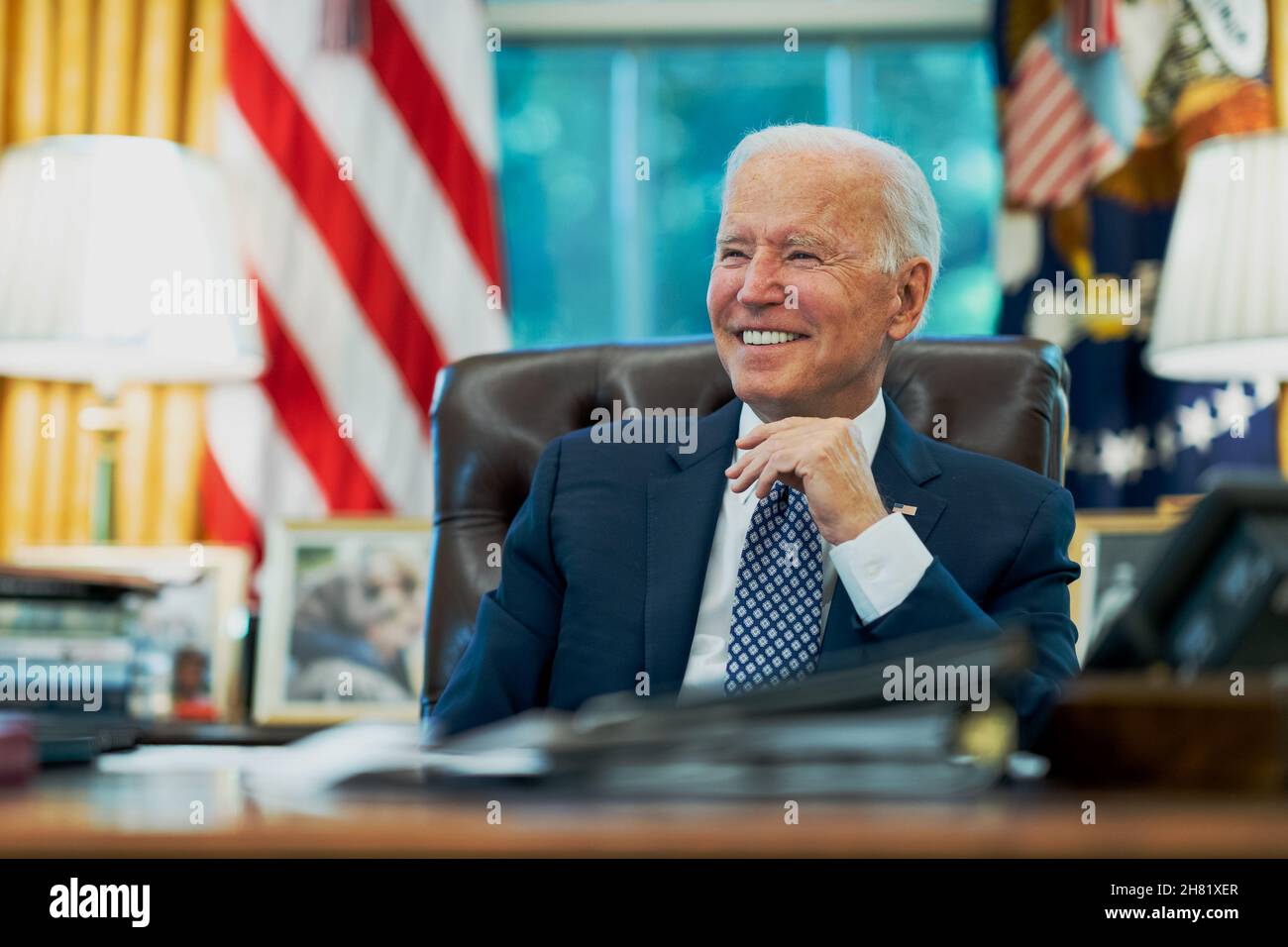 WASHINGTON DC, USA - 24 August 2021 - US President Joe Biden talks on the phone with Tennessee Governor Bill Lee, R-Tenn., Tuesday, Aug. 24, 2021, in Stock Photo