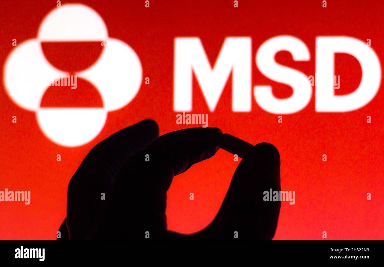 Brazil. 26th Nov, 2021. In this photo illustration a Merck Sharp & Dohme (MSD) logo is seen on a screen and a hand holding a pill. Credit: SOPA Images Limited/Alamy Live News Stock Photo