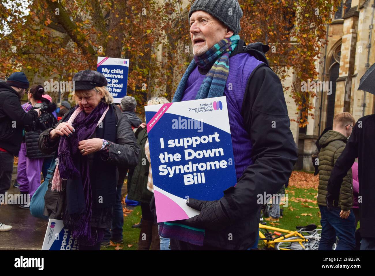 A demonstrator holds a placard in support of the Down Syndrome Bill