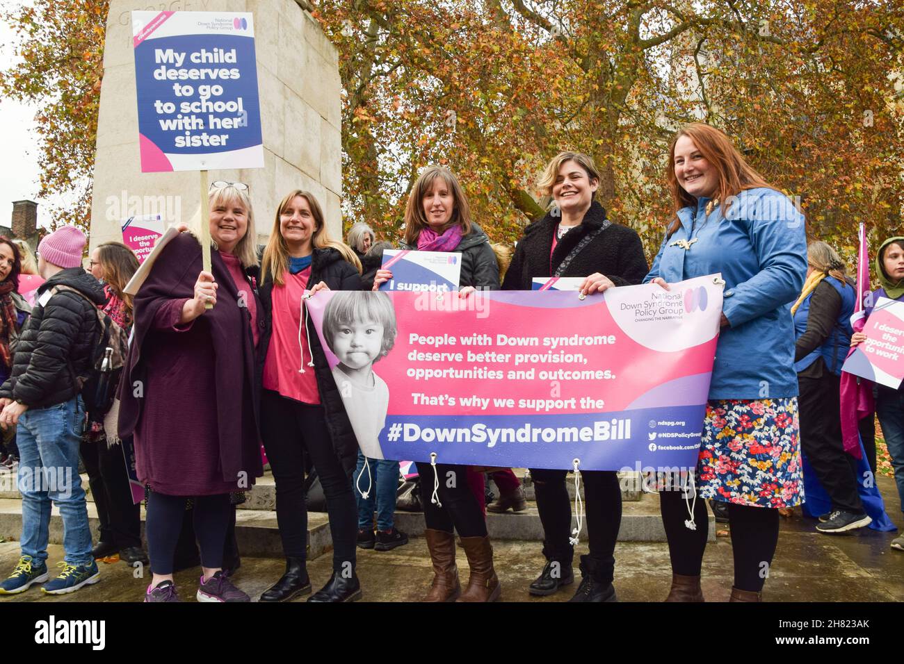 London, UK. 26th Nov, 2021. Demonstrators hold placards and a banner in