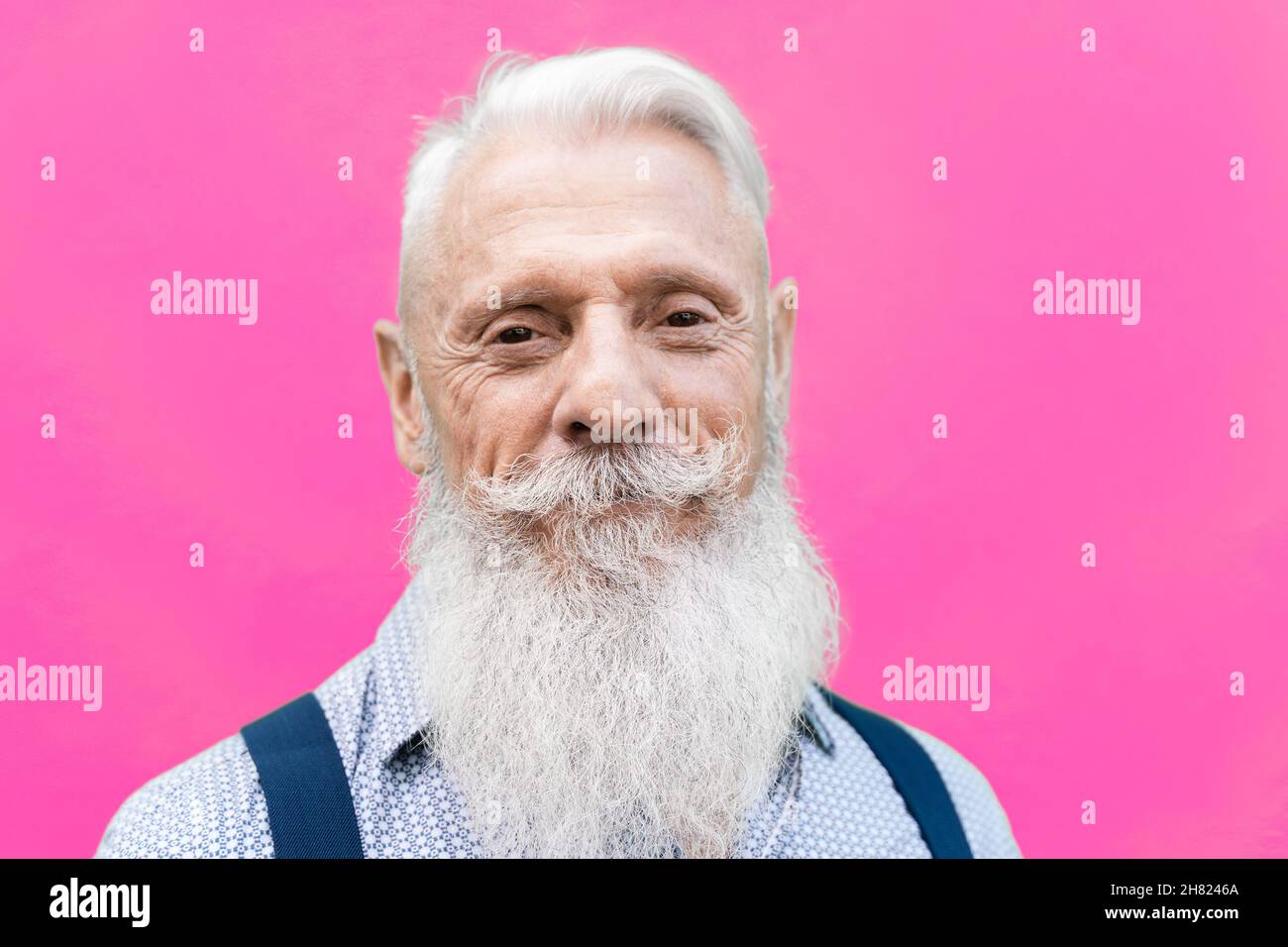 Portrait of happy hipster senior man smiling on camera - Focus in face Stock Photo