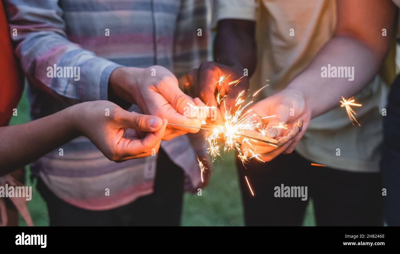 Happy friends celebrating together with sparklers on new year eve Stock Photo