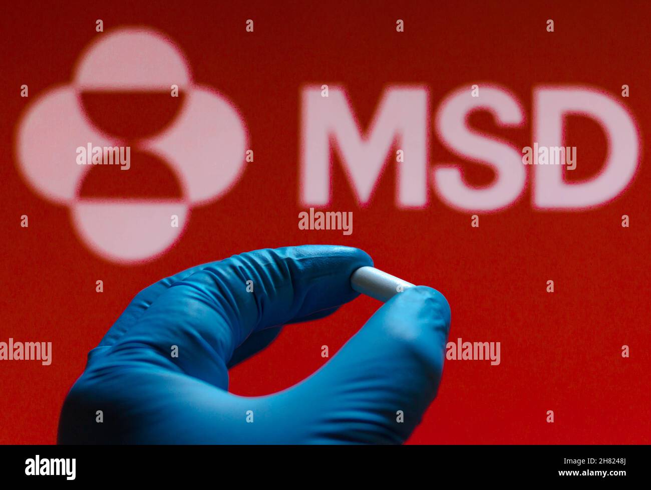 Brazil. 26th Nov, 2021. In this photo illustration a Merck Sharp & Dohme (MSD) logo is seen on a screen and a hand holding a pill. (Photo by Rafael Henrique/SOPA Images/Sipa USA) Credit: Sipa USA/Alamy Live News Stock Photo
