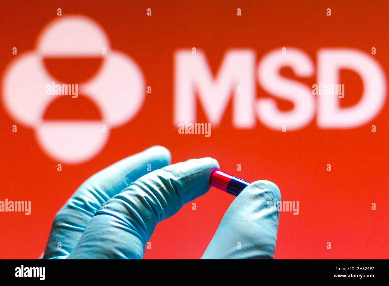 Brazil. 26th Nov, 2021. In this photo illustration a Merck Sharp & Dohme (MSD) logo is seen on a screen and a hand holding a pill. (Photo by Rafael Henrique/SOPA Images/Sipa USA) Credit: Sipa USA/Alamy Live News Stock Photo