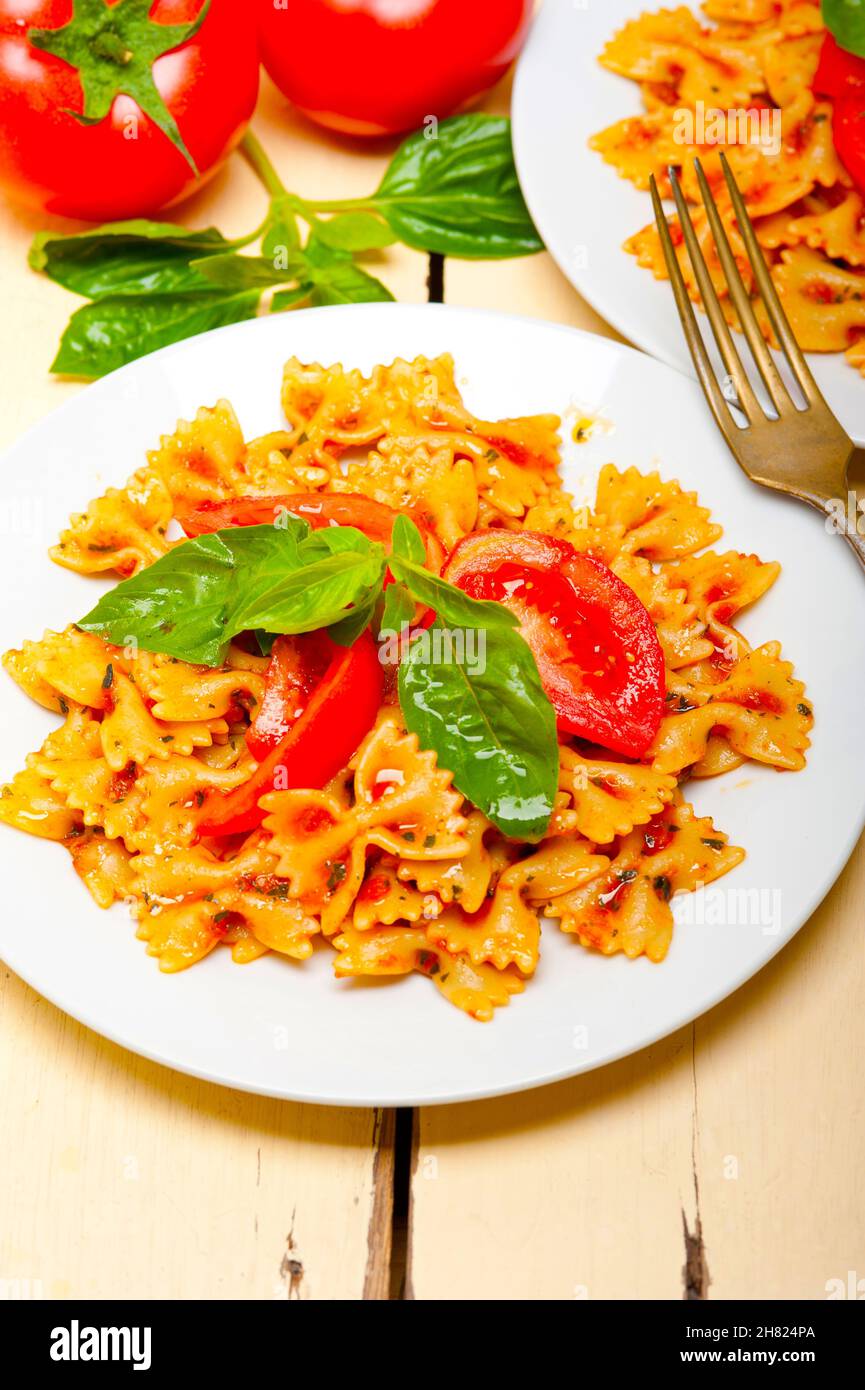 Italian pasta farfalle butterfly bowtie with tomato basil sauce over