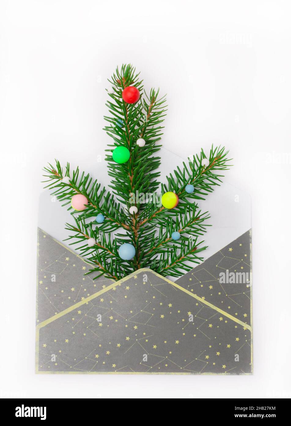 mailing envelope with green fir branches and bright balloons. Christmas ...