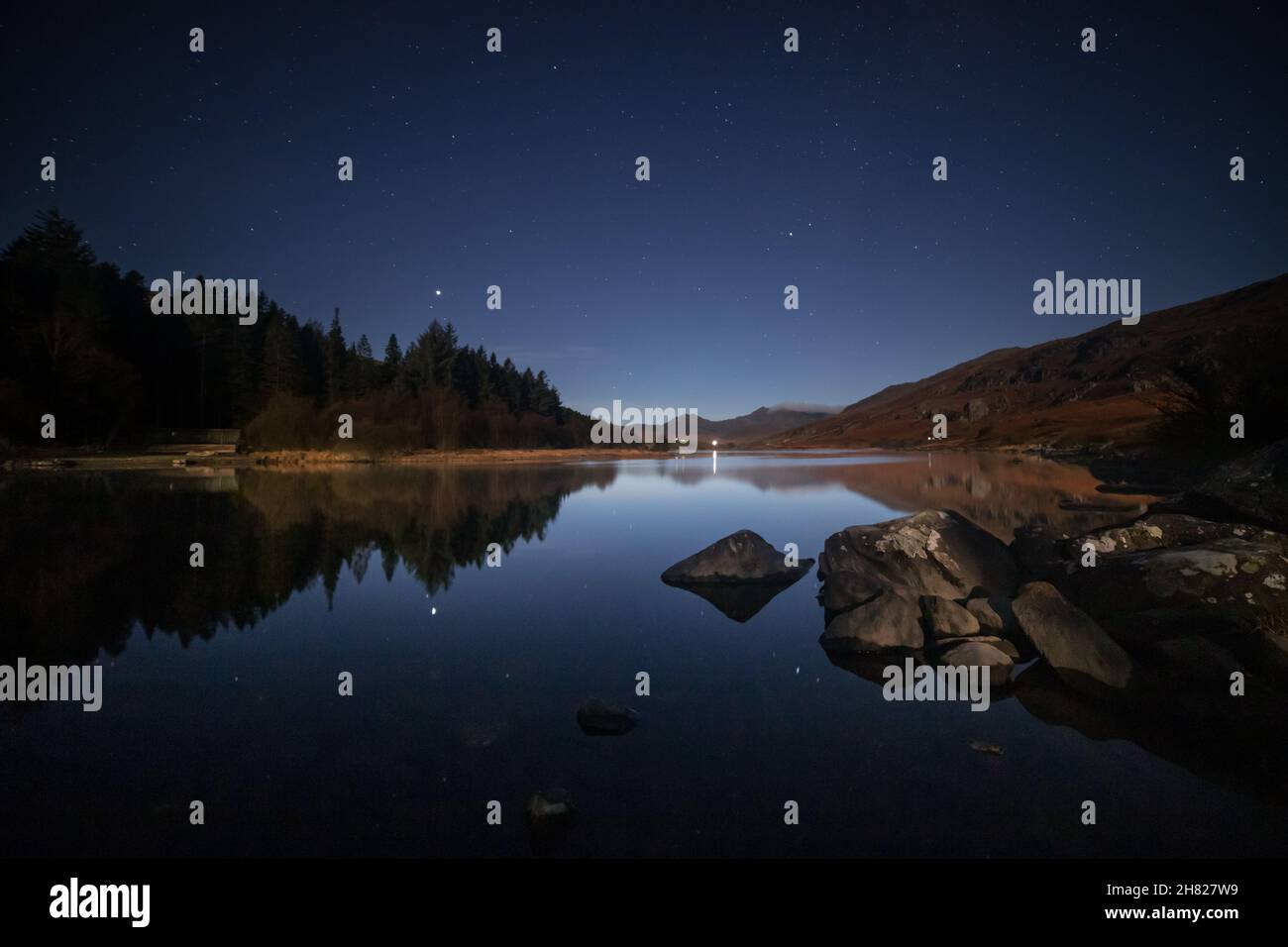 Reflection of a starry night sky at Llyn Mymbyr, Snowdonia, North Wales Stock Photo