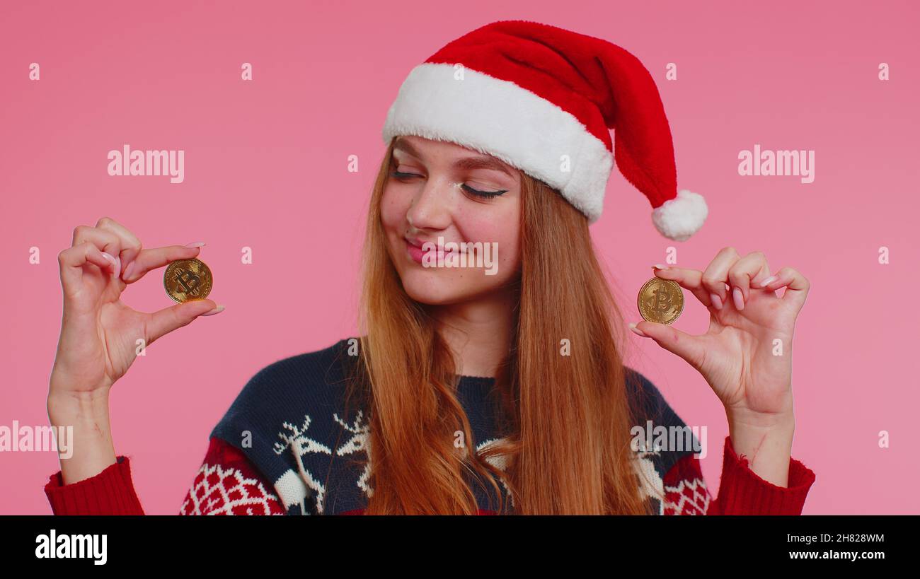 Girl in Christmas sweater showing golden bitcoins BTC cryptocurrency money  investment, mining future Stock Photo - Alamy