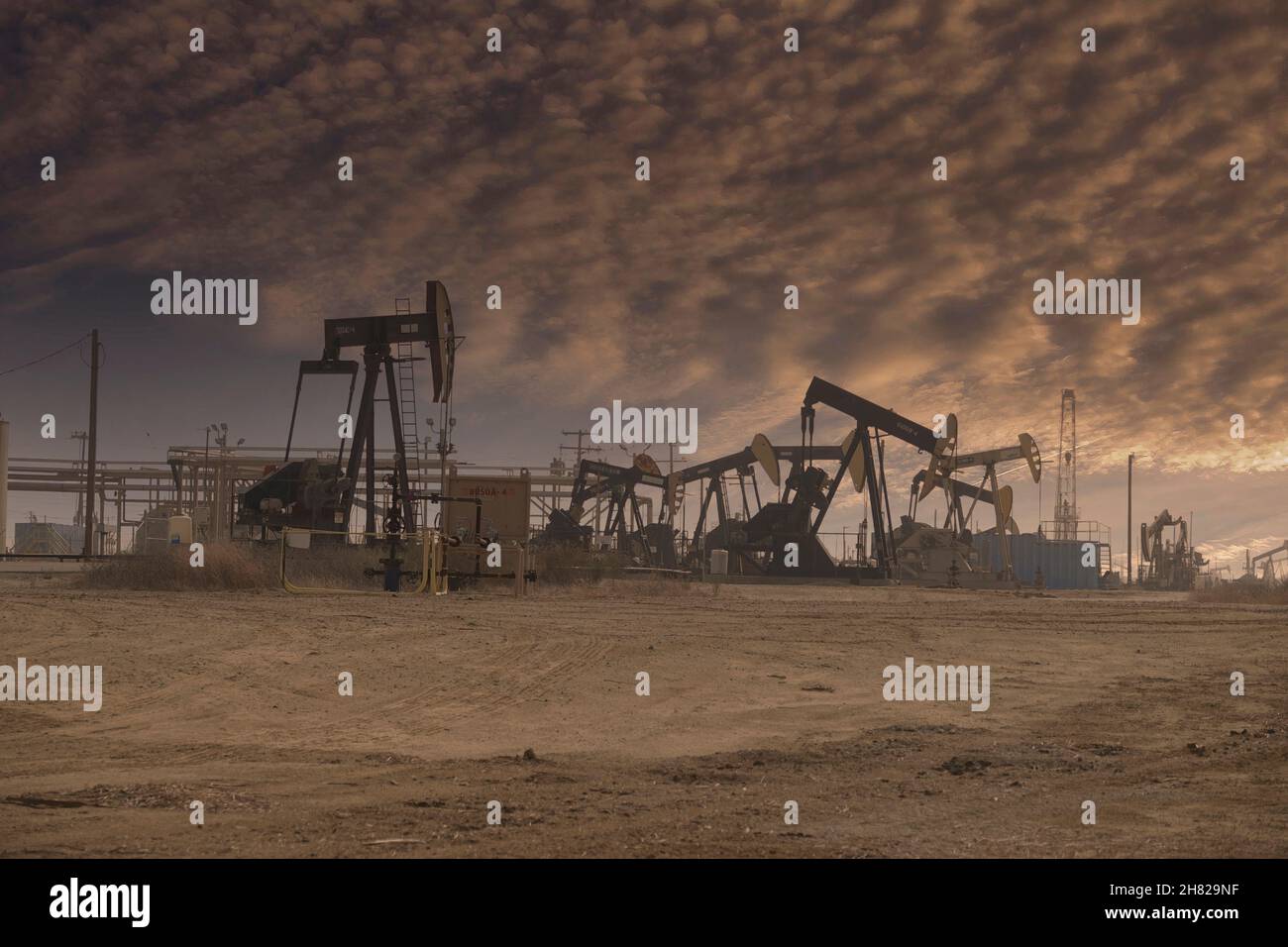 Moody light hovers over the Lost Hills oil field north west of